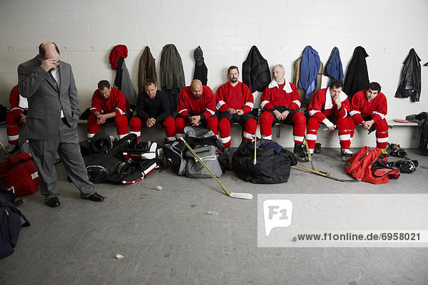 Coach and Hockey Players in Dressing Room