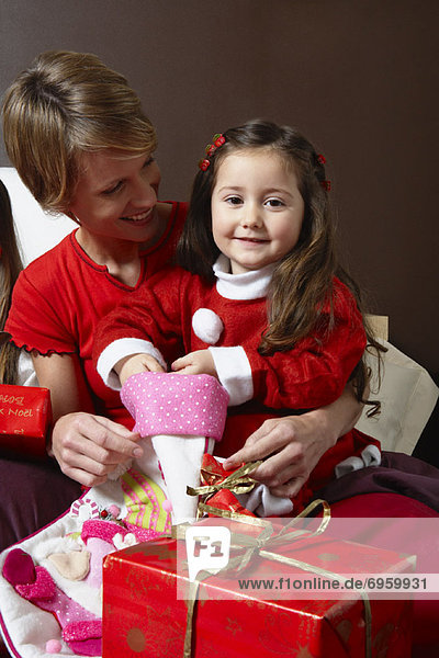 Mother and Daughter Opening Christmas Stocking