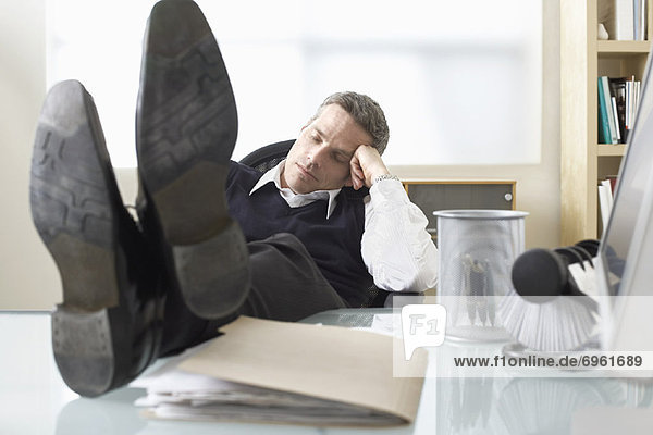 Businessman Asleep at Desk