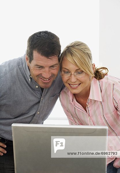Couple Looking at Computer Screen Together
