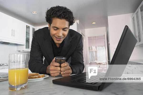 Businessman at Home  Reading Text Message