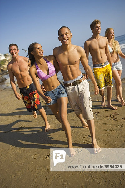 Teenagers Walking on Beach
