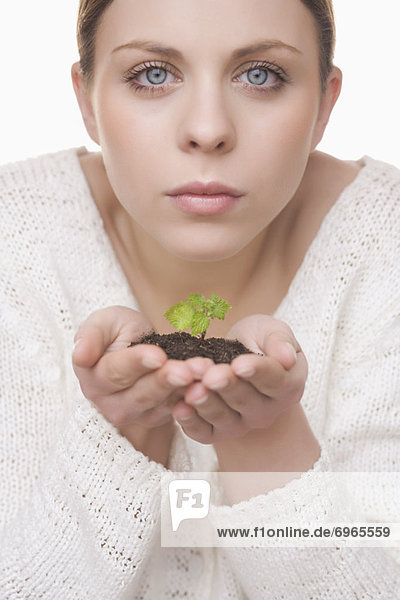 Woman Holding Plant in Soil