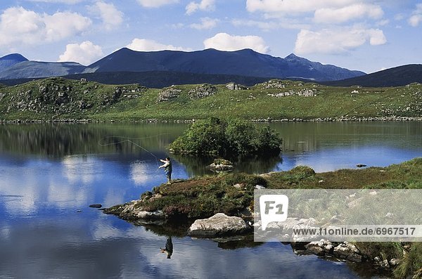 High Angle View Of A Man Fishing In The Lake  Barfinnihy Lake  Republic Of Ireland