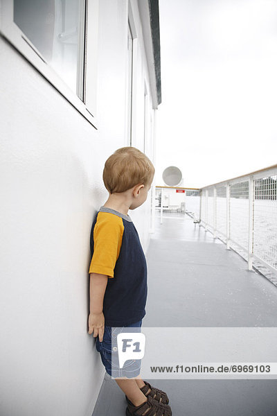 Boy Standing on Deck of Ship