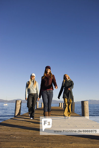 Three Women Walking on Dock