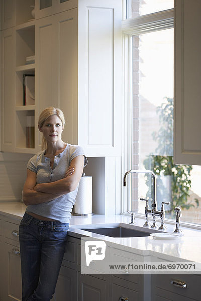 Woman Leaning on Kitchen Counter