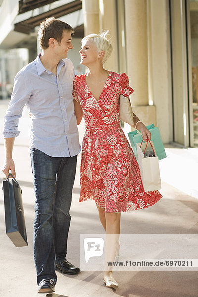 Young Couple Shopping on Street with Shopping Bags