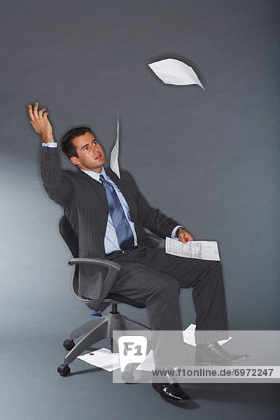 Frustrated Businessman Throwing Documents in Air