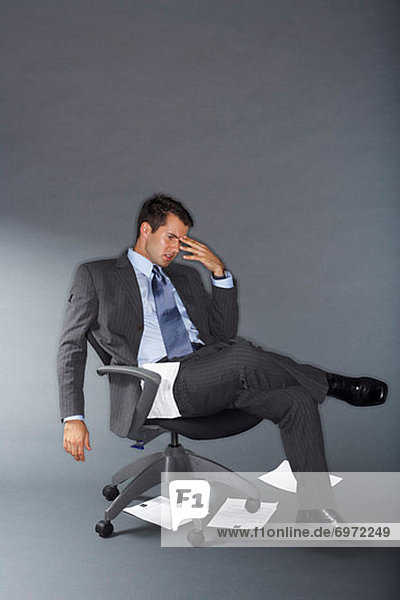 Frustrated Businessman With Documents on the Floor