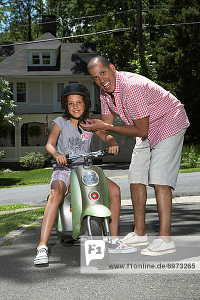 Portrait of Father and Daughter with Scooter