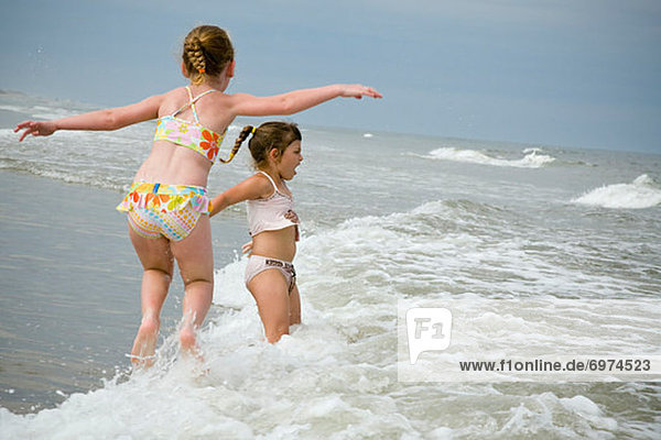 Girls Playing in Waves  Cape Hatteras  North Carolina  USA