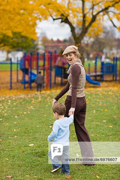 Mother and Son Walking in the Park in Autumn  Portland  Oregon  USA