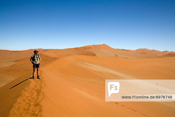Woman Standing on Sand Dune  Namib-Naukluft National Park  Namibia