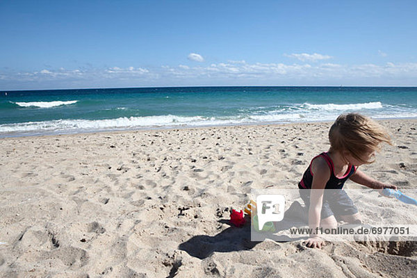 Girl Digging on Beach  Fort Lauderdale  Florida  USA