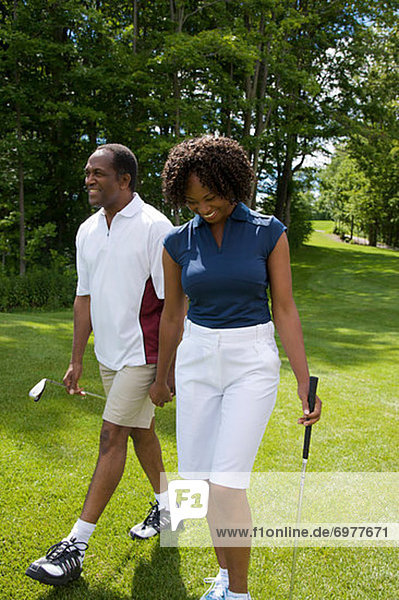 Couple Walking on Golf Course