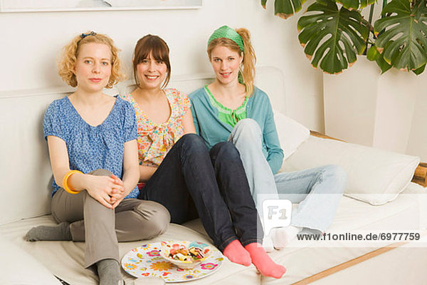 Portrait of Women Sitting on Sofa