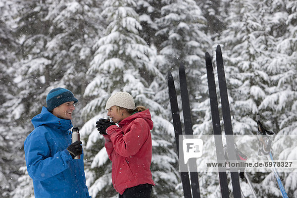 Couple Drinking from Thermos  Cross Country Skiing  Whistler  British Columbia  Canada