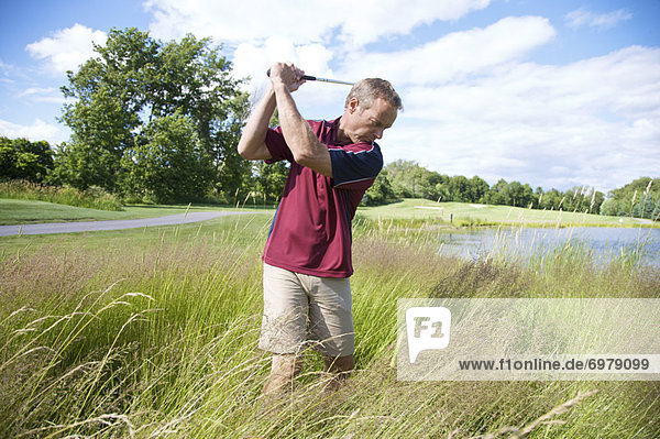 Man Golfing in Tall Grass