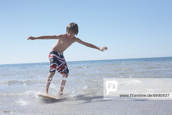 Boy Skimboarding at Deanlea Beach  Elmvale  Ontario  Canada
