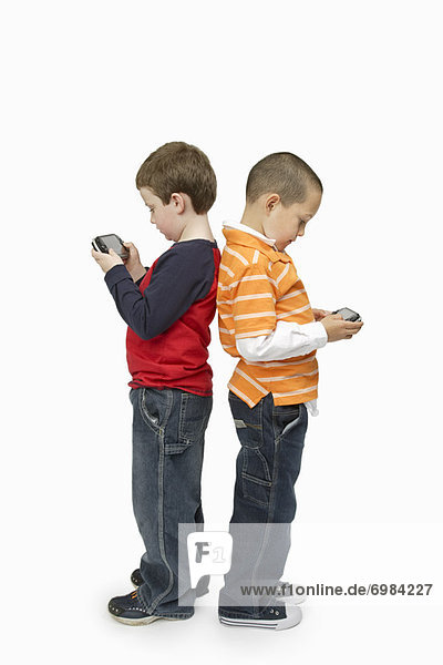 Boys with Handheld Video Games Standing Back to Back