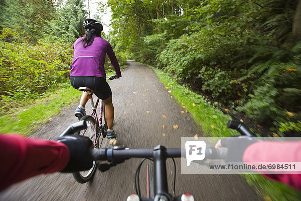 Women Riding Bikes in Forest  Seattle  Washington  USA