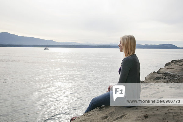 Woman Sitting on the Beach  Vancouver  BC  Canada