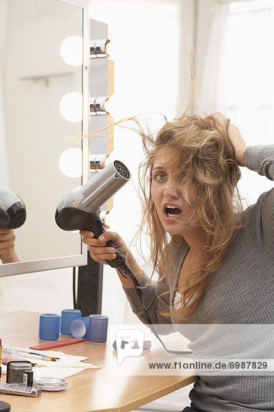 Teenager Using Hair Dryer