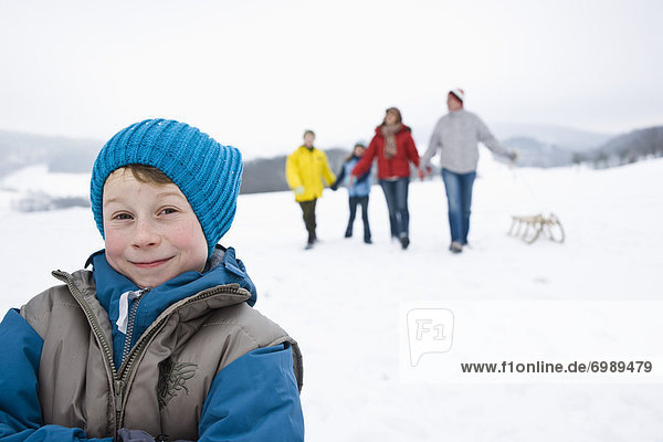 Boy Outdoors in Winter with Family