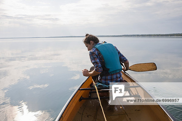 Woman Canoeing  Clearwater Lake  Clearwater Lake Provincial Park  Manitoba  Canada