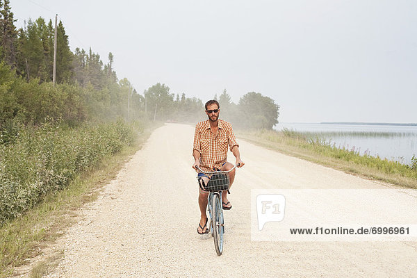 Man Riding Bike  Clearwater Lake Provincial Park  Manitoba  Canada