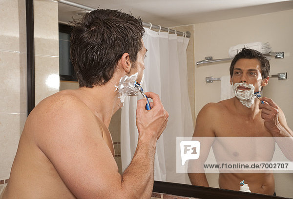 Man Shaving in Hotel Room  Reef Playacar Resort and Spa  Playa del Carmen  Mexico