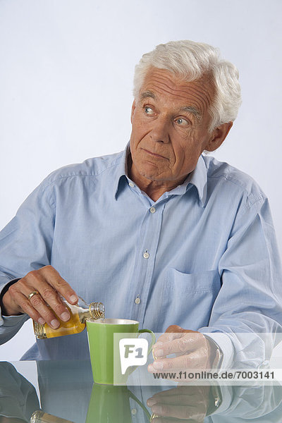 Man adding Alcohol to his Coffee
