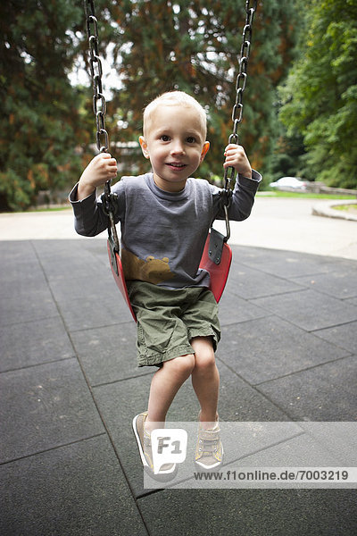 Boy Playing on Swings  Washington Park Playground  Portland  Oregon  USA