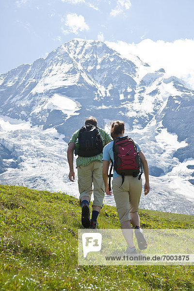 Backview of Couple Hiking  Bernese Oberland  Switzerland