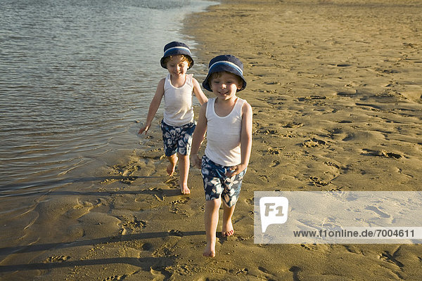 Twin boys Walking on Beach