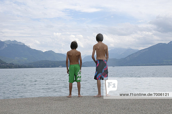 Back View of Boys Standing on Shore of Lake  Annecy  Alps  France