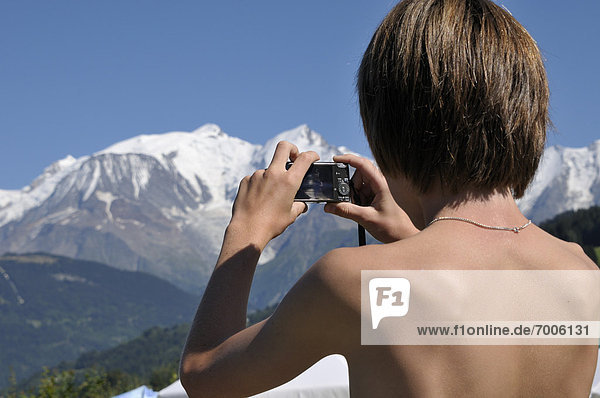 Back View of Boy taking Picture of Mountains  Alps  France