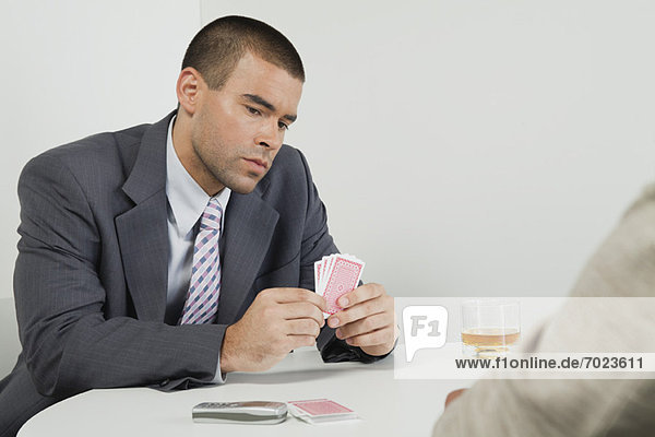 Businessman playing cards
