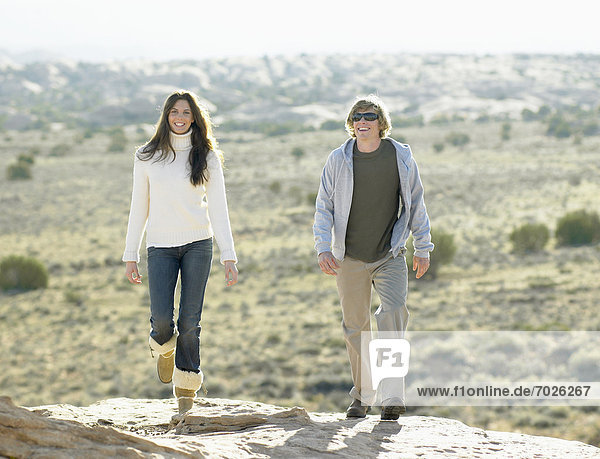 Woman and man walking in desert