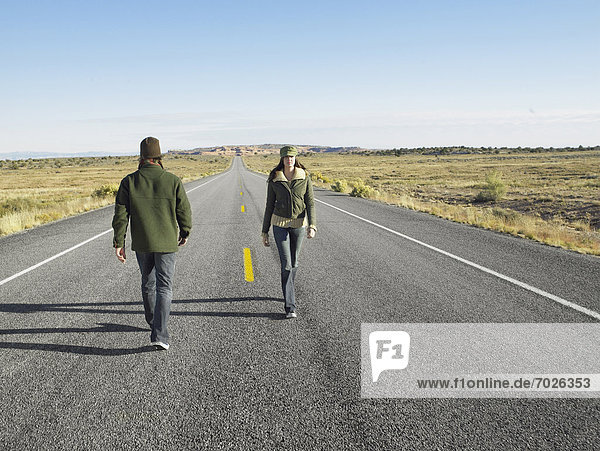 Man and woman passing each other on wrong sides of road
