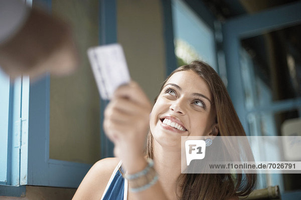 Woman giving credit card to man