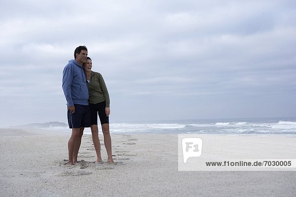 Mid adult couple looking at view on beach  Cape Town  South Africa
