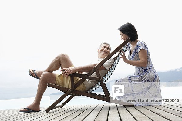 Mature couple relaxing on deck