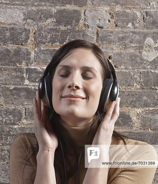 Mid-Adult Woman Listening to Headphones
