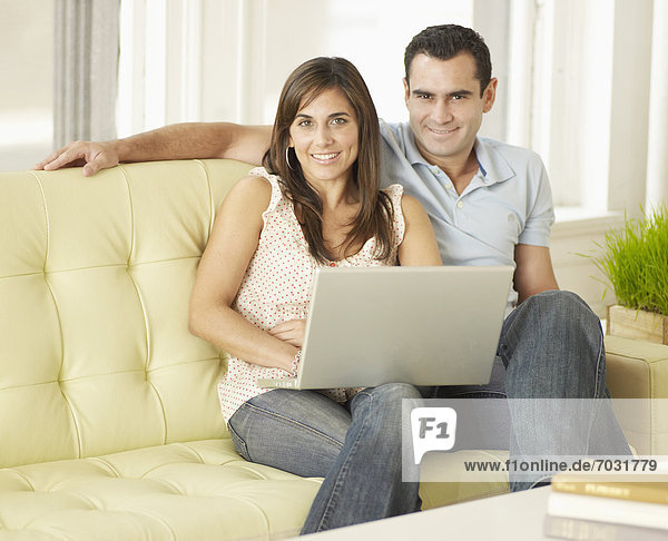 Mid-Adult Couple Using Laptop