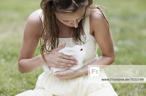 Mid-Adult Woman Holding White Rabbit