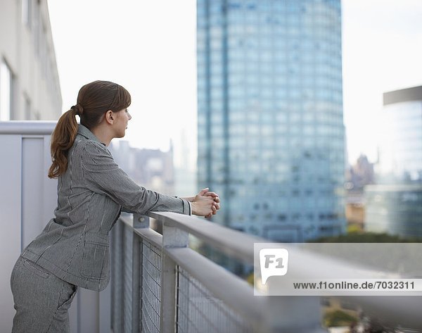 Businesswoman Looking at View on Balcony