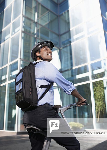 Businessman with Solar Panelled Backpack on Folding Bike