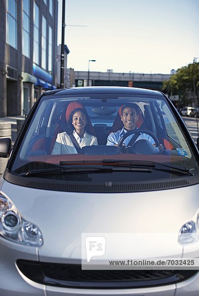 Mid-Adult Couple Driving Smart Car